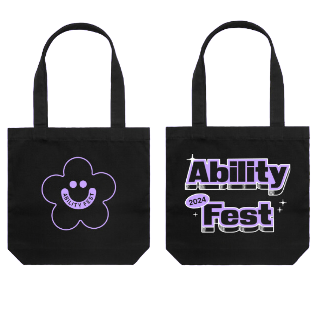 Side by side shot of a black tote bag. Left side shows the outline of a purple flower with a purple ability fest smiley logo in the middle. The right shows the black words Ability Fest, 2024 in block letters outlined in purple.